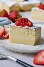 Vanilla Cake- Light And Fluffy Vanilla Sponge Cake
 Layered With Creamy Vanilla Custard Topped With a
 Dusting Of Powdered Sugar and Fresh Barries